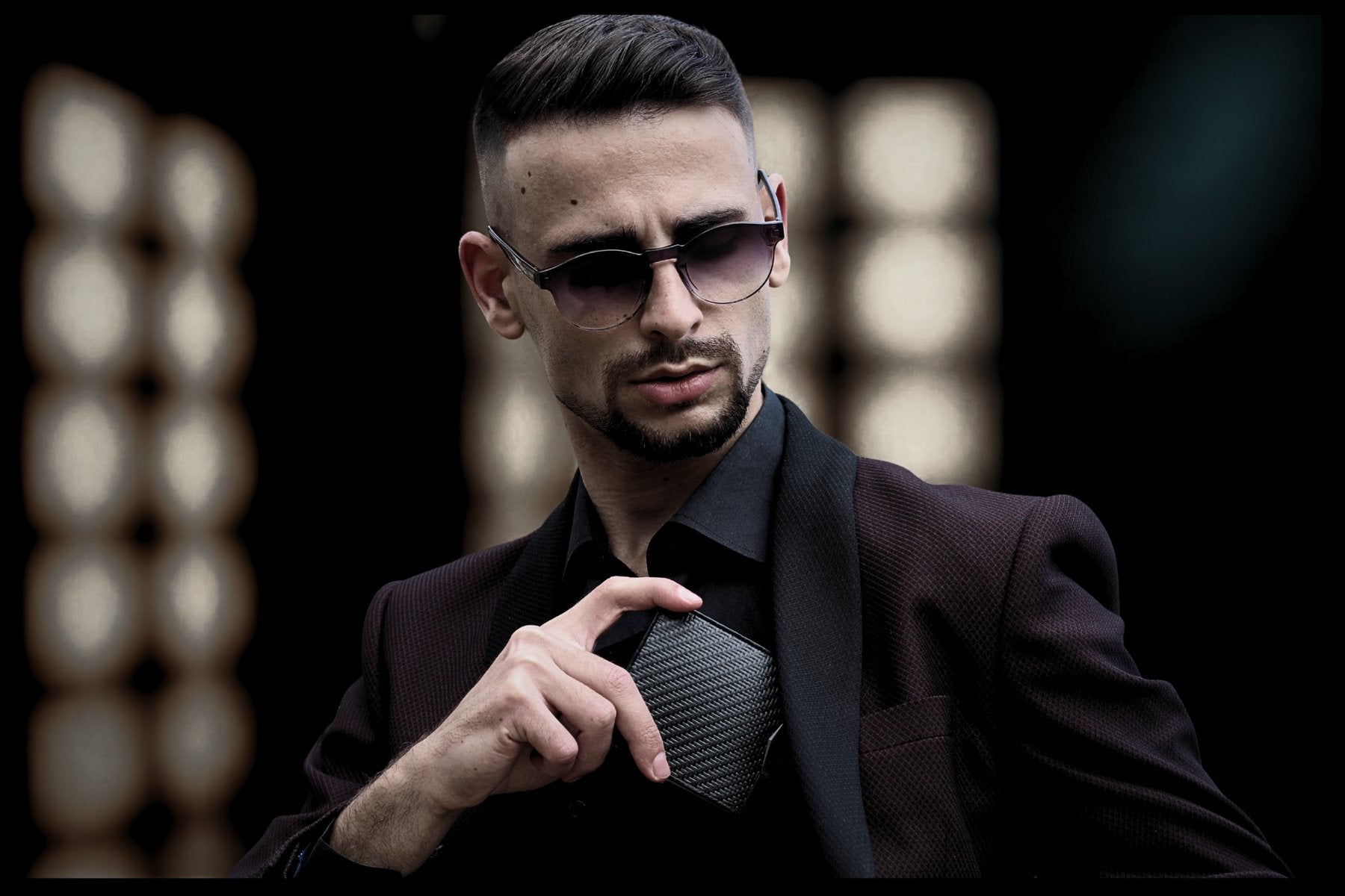 Man in blazer pulling ColdFire carbon fiber wallet from chest pocket